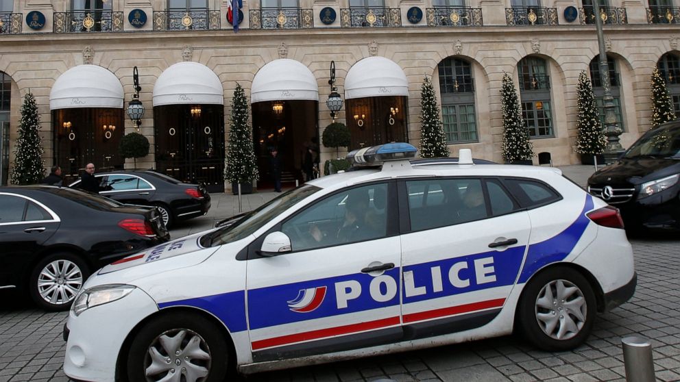 FILE - In this April 15, 2020 file photo a police car drives past the Ritz hotel in Paris. One of France's biggest unsolved criminal cases appears to have been cracked. Prosecutors announced that DNA from a 59-year-old former gendarme who killed hims