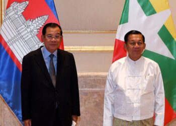 FILE - In this photo provided by An Khoun Sam Aun/National Television of Cambodia, Cambodian Prime Minister Hun Sen, left, poses for photographs together with Myanmar State Administration Council Chairman, Senior General Min Aung Hlaing, right, befor