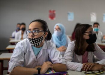 Students wear robes and face masks as they attend first day of new school year in Rabat, Morocco, Friday, Oct. 1 2021. Morocco delayed the return of schools until first of October to vaccinate 12-17 year old children against covid-19. (AP Photo/Mosa'