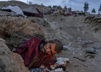 An Afghan drug addict smokes heroin on the edge of a hill in the city of Kabul, Afghanistan,Tuesday, June 7, 2022. Drug addiction has long been a problem in Afghanistan, the world’s biggest producer of opium and heroin. The ranks of the addicted have