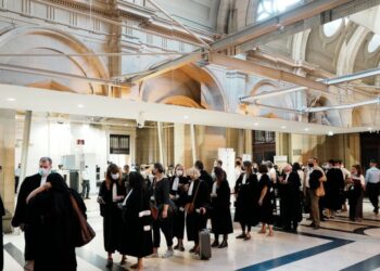 FILE - Lawyers and participants arrive at the special courtroom Wednesday, Sept. 8, 2021 in Paris. French prosecutors on Friday laid out their demands for sentences in the historic Paris trial of 20 men suspected of critical roles in France's worst p