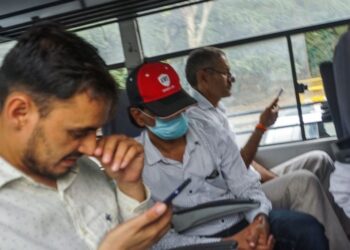 FILE- Indian journalist Mohammed Zubair, center, wearing cap, sits in a police vehicle after being produced in a court in New Delhi, India, June 28, 2022. India’s top court Wednesday granted bail to the Muslim journalist and ordered his release from