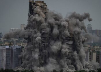 Cloud of dust rises as twin high-rise apartment towers are razed to ground in Noida, outskirts of New Delhi, India, Sunday, Aug. 28, 2022. The demolition was done after the country's top court declared them illegal for violating building norms. The 3