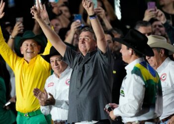 Brazilian President Jair Bolsonaro, center, who is running for a second term, greets supporters at the the Barretos Rodeo International Festival in Barretos, Sao Paulo state Brazil, Friday, Aug. 26, 2022. Brazil's general elections are scheduled for