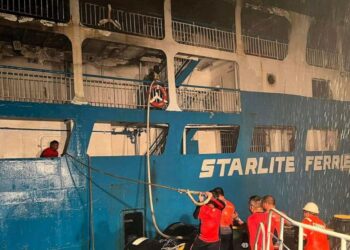 In this handout photo provided by the Philippine Coast Guard, Coast guard personnel help in controlling the fire of M/V Asia Philippines, an inter-island cargo and passenger vessel, they were riding caught fire while it was approaching Batangas port,