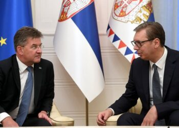 In this photo provided by the Serbian Presidential Press Service, Serbian President Aleksandar Vucic, right, speaks with European Union envoy Miroslav Lajcak in Belgrade, Serbia, Thursday, Aug. 25, 2022. Tensions between Serbia and Kosovo soared anew