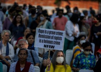 A woman holds a placard during a protest against remission of sentence by the government to convicts of a gang rape of a Muslim woman, in New Delhi, India, Saturday, Aug. 27, 2022. The victim, who is now in her 40s, was pregnant when she was brutally