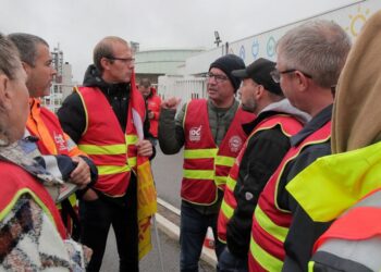 Striking workers gather at the entrance of the TotalEnergies oil depot, Thursday, Oct.13, 2022 outside Dunkirk, northern France. French President Emmanuel Macron promised the situation in the country's gas stations will soon be back to "normal" as th