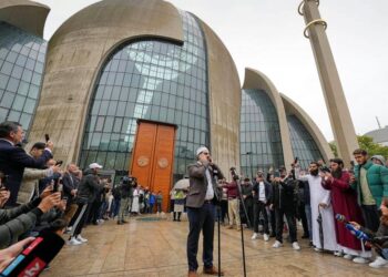 Muezzin Mustafa Kader recites the call to prayer at the Cologne Central Mosque in Cologne, Germany, Friday, Oct. 14, 2022. The Islamic call to prayer is set to sound for the first time from one of Germany’s biggest mosques in Cologne on Friday — but