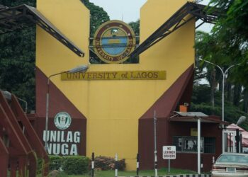 FILE- Cars drive past the University of Lagos gate in Nigeria, Wednesday Aug. 17, 2022. Nigerian lecturers have called off their strike embarked upon in February to protest issues relating to their welfare, according to Emmanuel Osodeke, president of