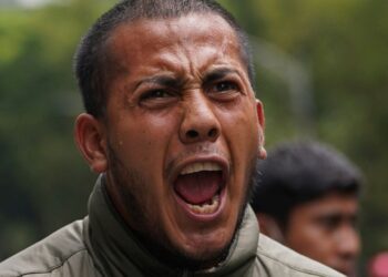 A demonstrator takes part in a march seeking justice for the missing 43 Ayotzinapa students in Mexico City, Friday, Aug. 26, 2022. Six of the 43 college students “disappeared” in 2014 were allegedly kept alive in a warehouse for days then turned over